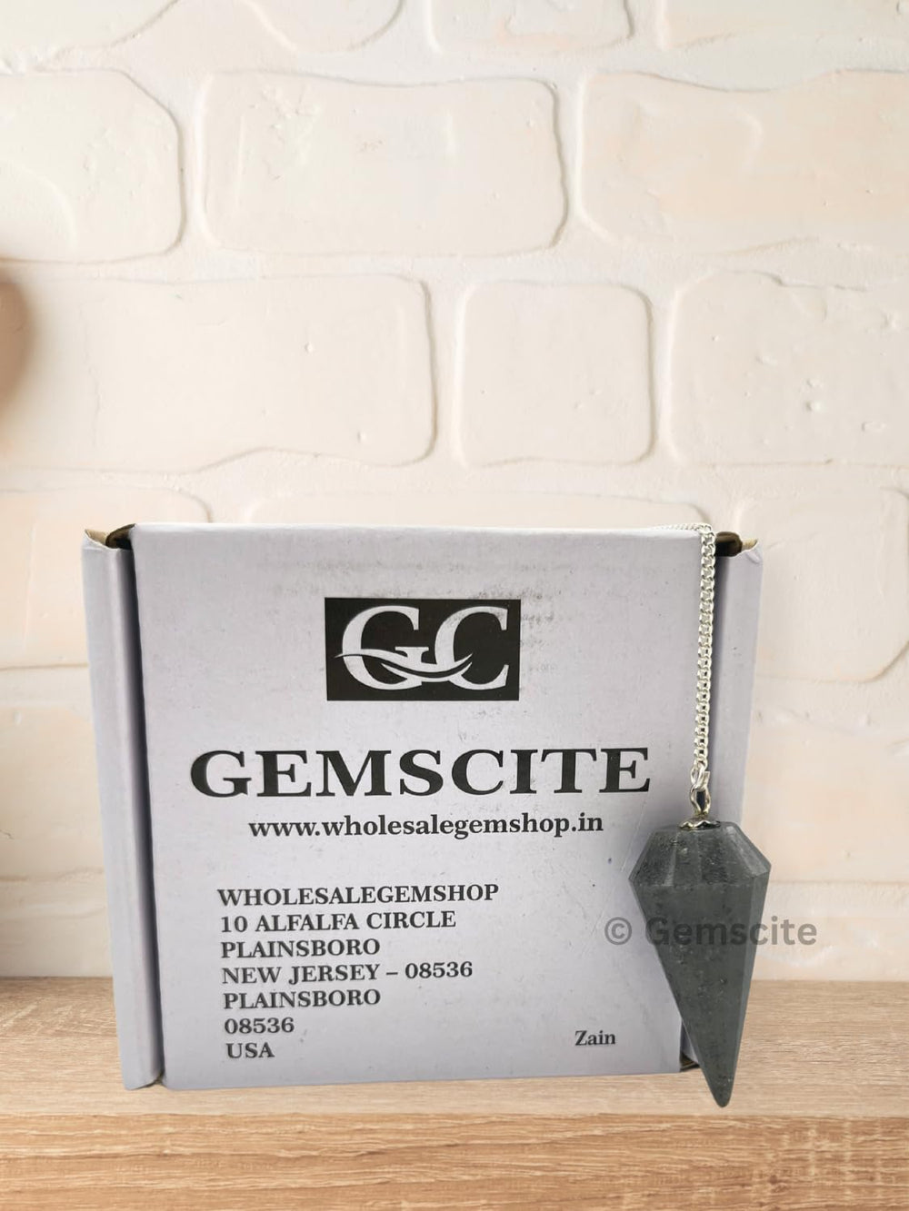 Wholesalegemshop Blue Aventurine Pendulum in hand for focus during practice