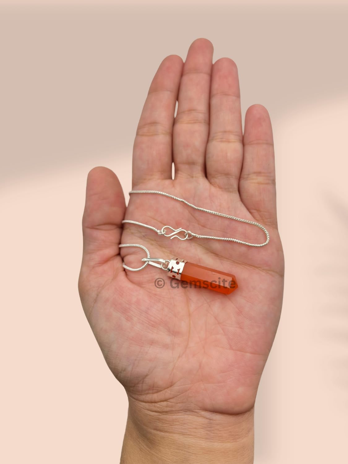 Gemscite pendant resting in hand emphasizes quality craftsmanship and vibe