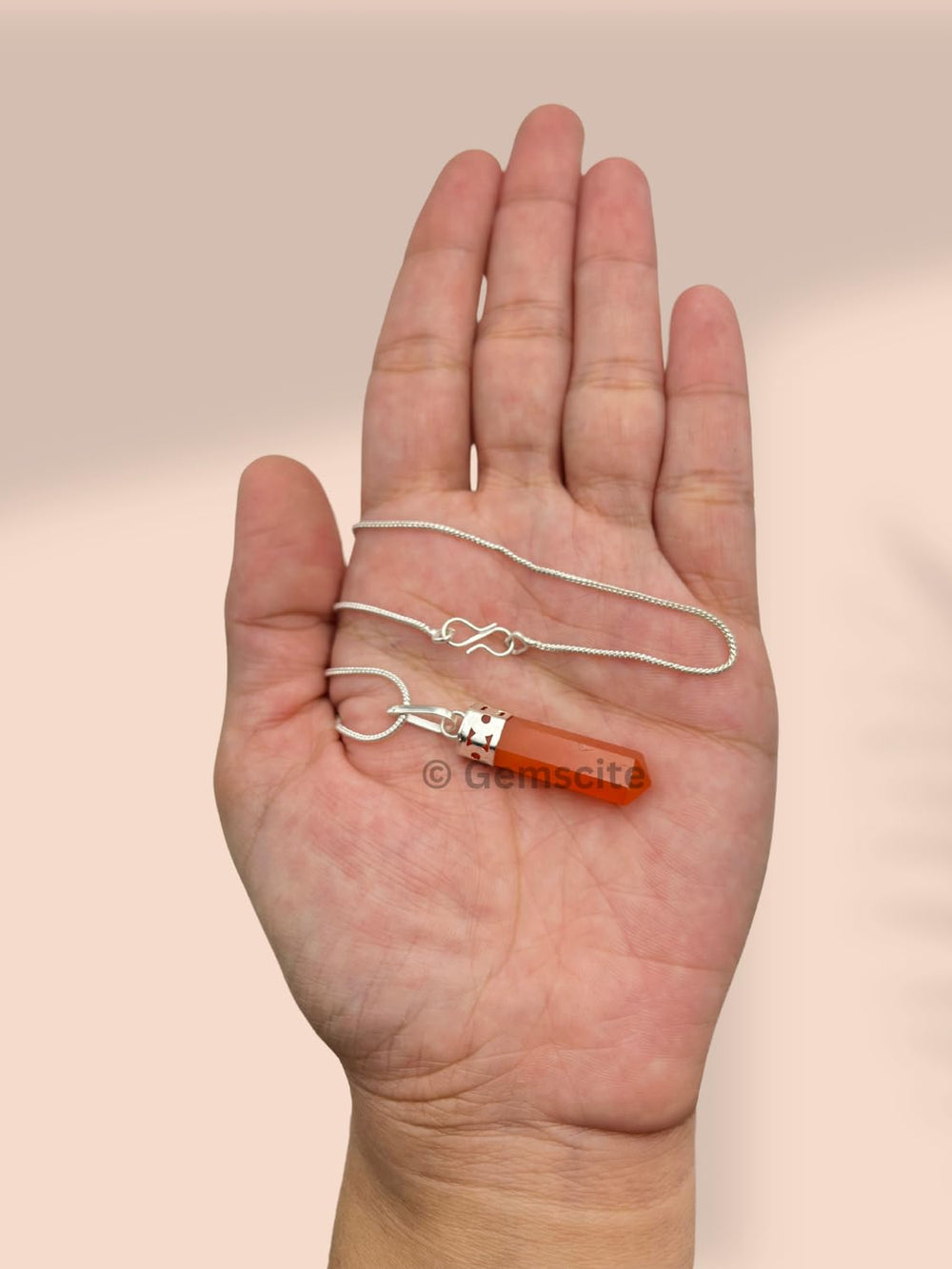 Gemscite pendant resting in hand emphasizes quality craftsmanship and vibe