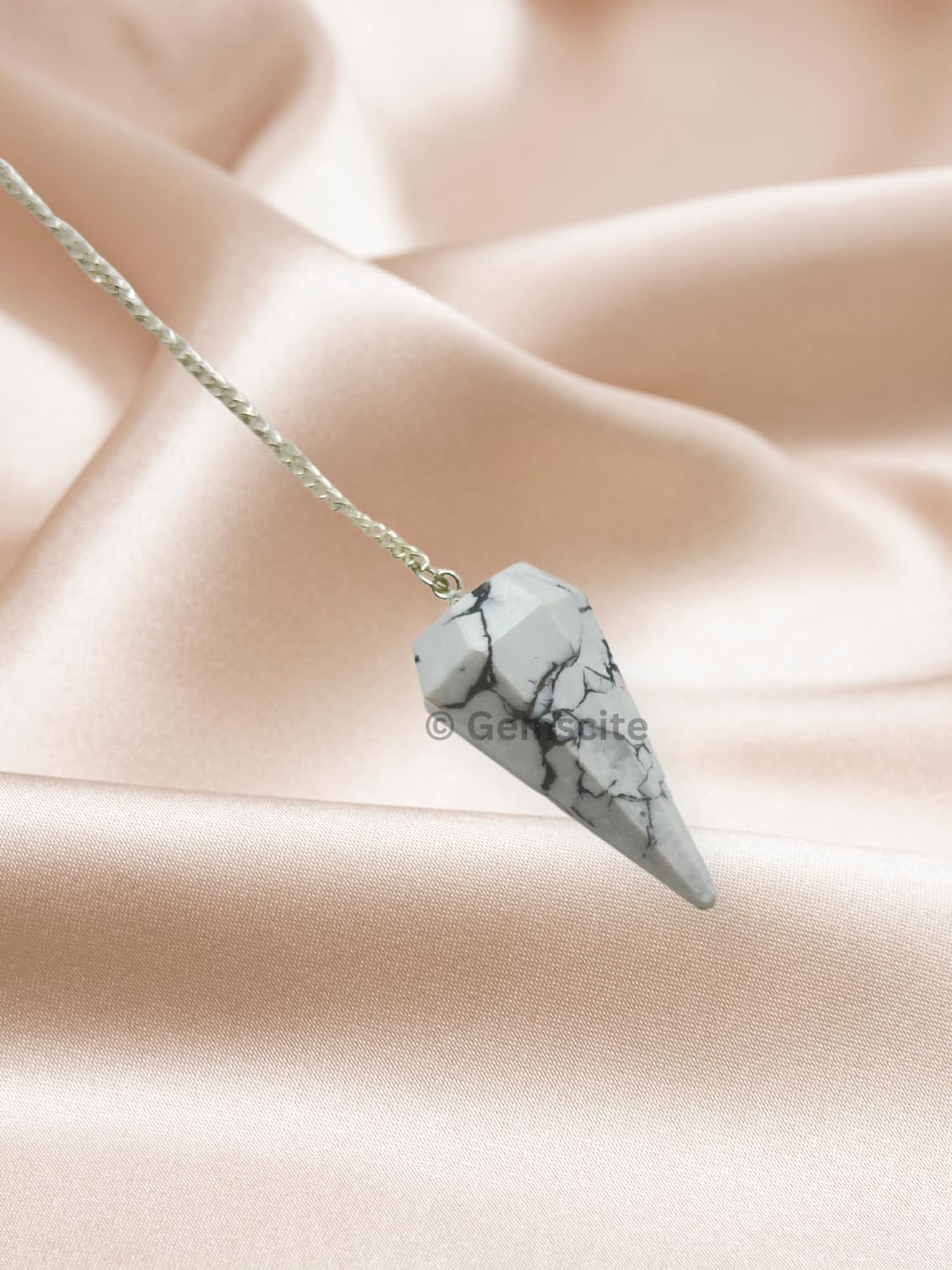 WholesaleGemShop Howlite pendulum with cord attachment ready for practice.
