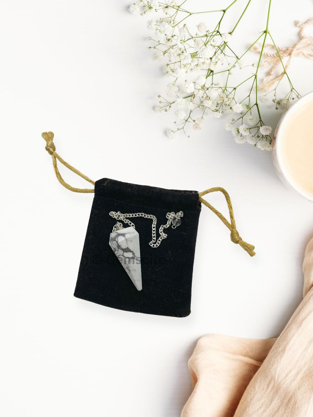 WholesaleGemShop Howlite pendulum in velvet pouch for elegant gifting.