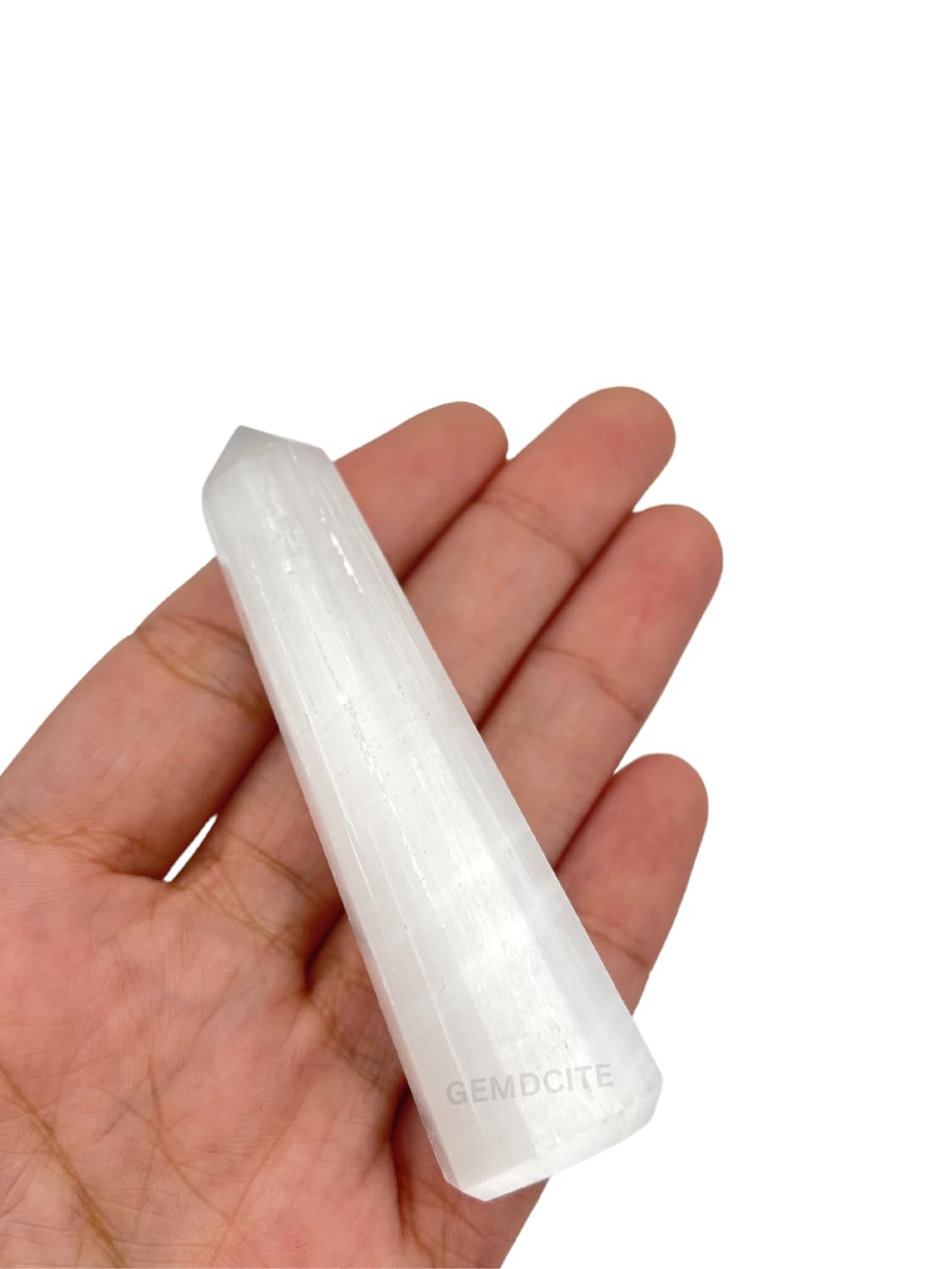 Wholesale Gem Shop selenite obelisk 70mm in dim light reveals subtle natural veining.