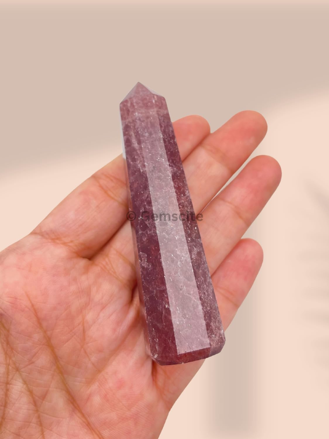 WholesaleGemShop Strawberry Quartz Obelisk lit to emphasize soft pink aura