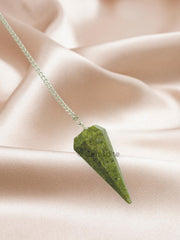 Close-up of Wholesale Gem Shop Vesuvianite pendulum in hand showing facets and glow