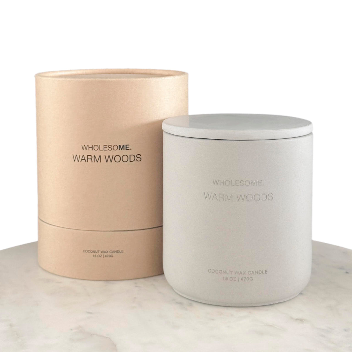 Wholesome Warm Woods candle in a concrete jar creates warm, inviting ambience.