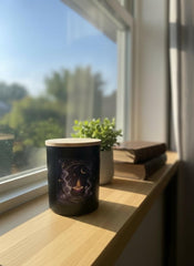 Wick & Whisper Astranova candle glow in a dusky room during journaling.