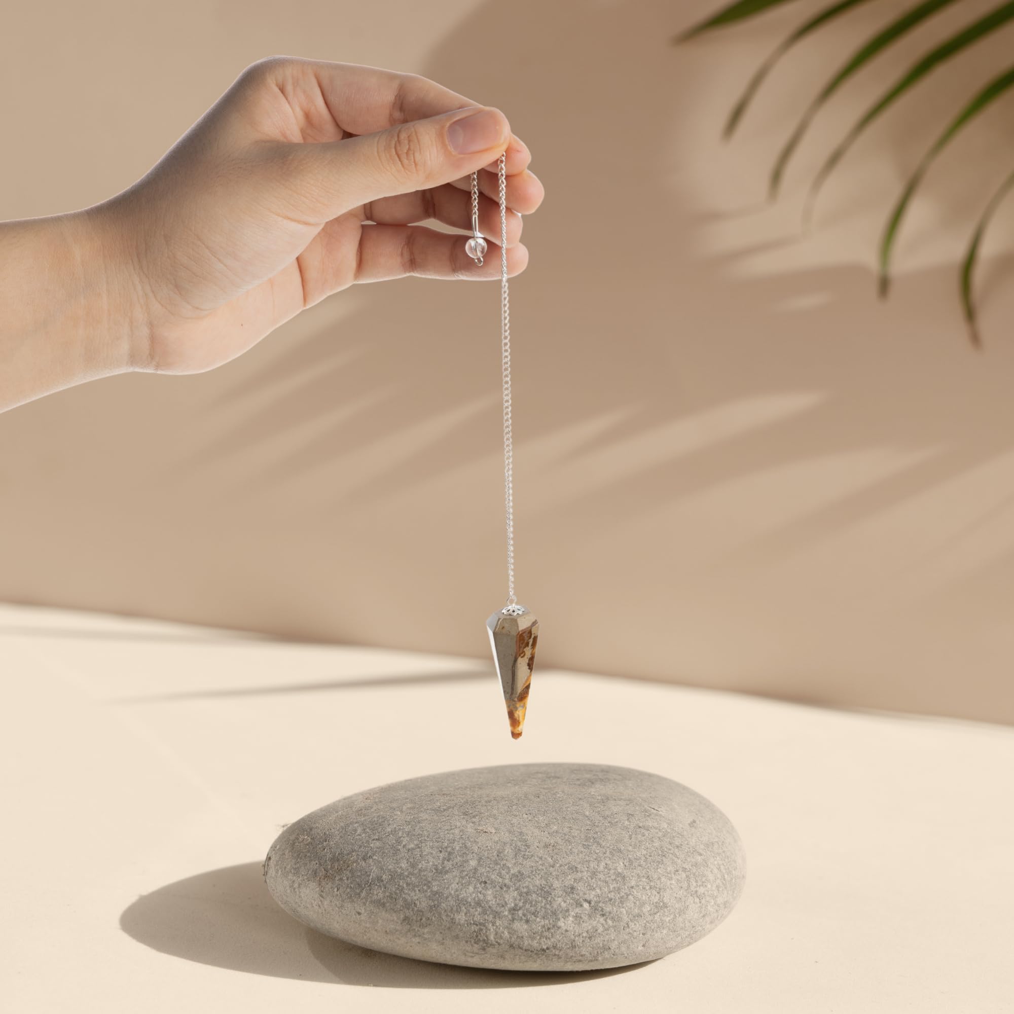 Wish Well divination pendulum in use for focused energy work.
