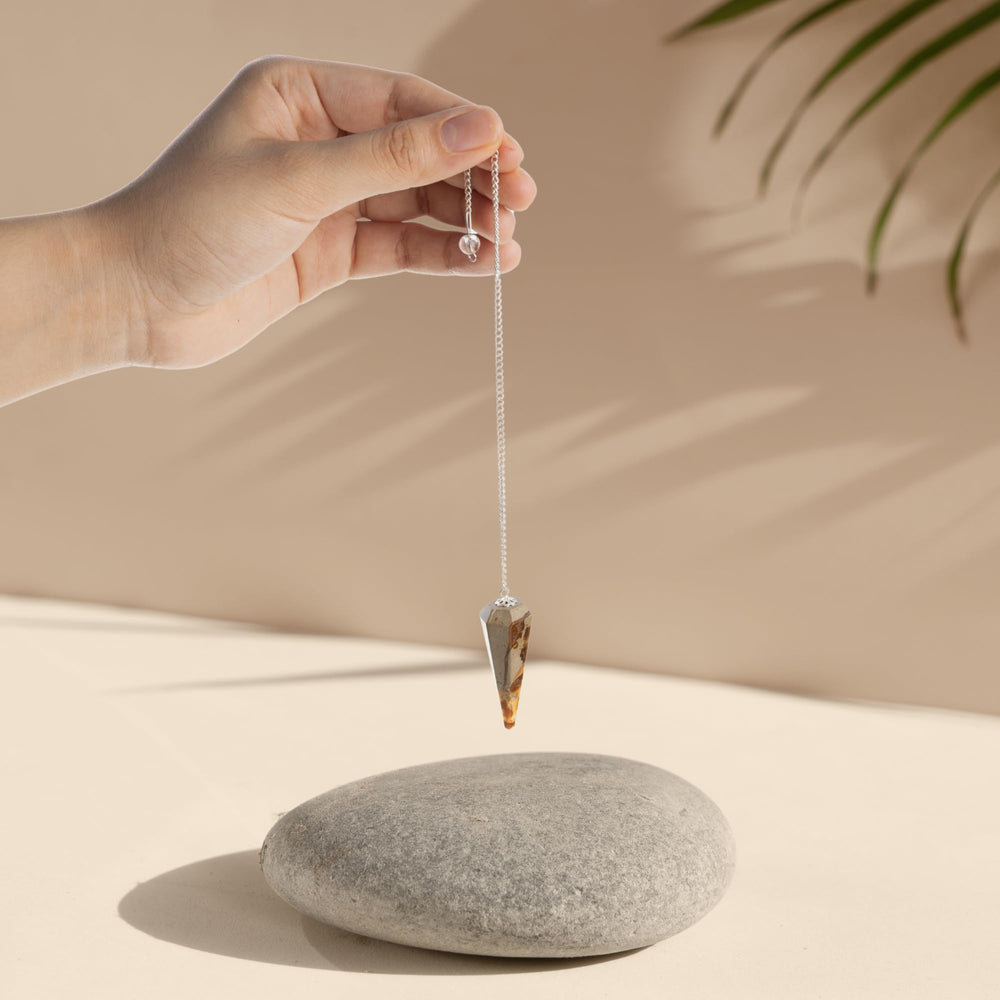 Wish Well divination pendulum in use for focused energy work.