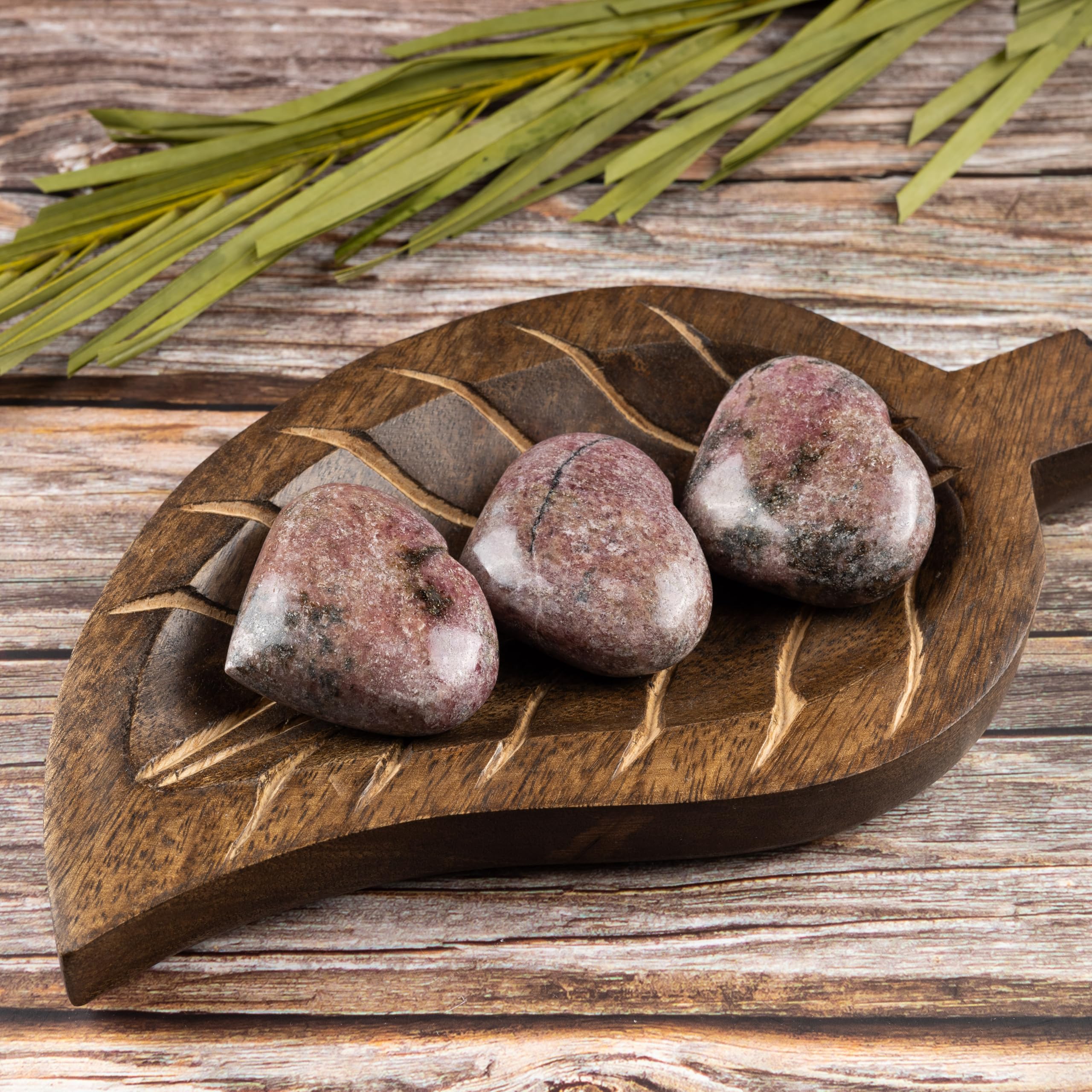 Wish Well Rhodonite heart stone in hand illustrating tactile calm during daily mindfulness