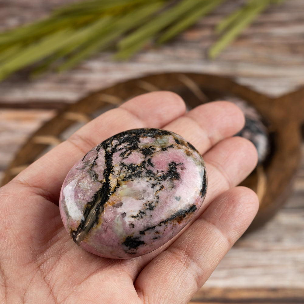 Wish Well Rhodonite palm stone with a polished finish aids mindful rituals