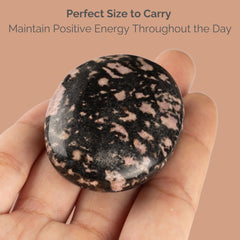 Wish Well Rhodonite palm stone in hand for grounding during stress