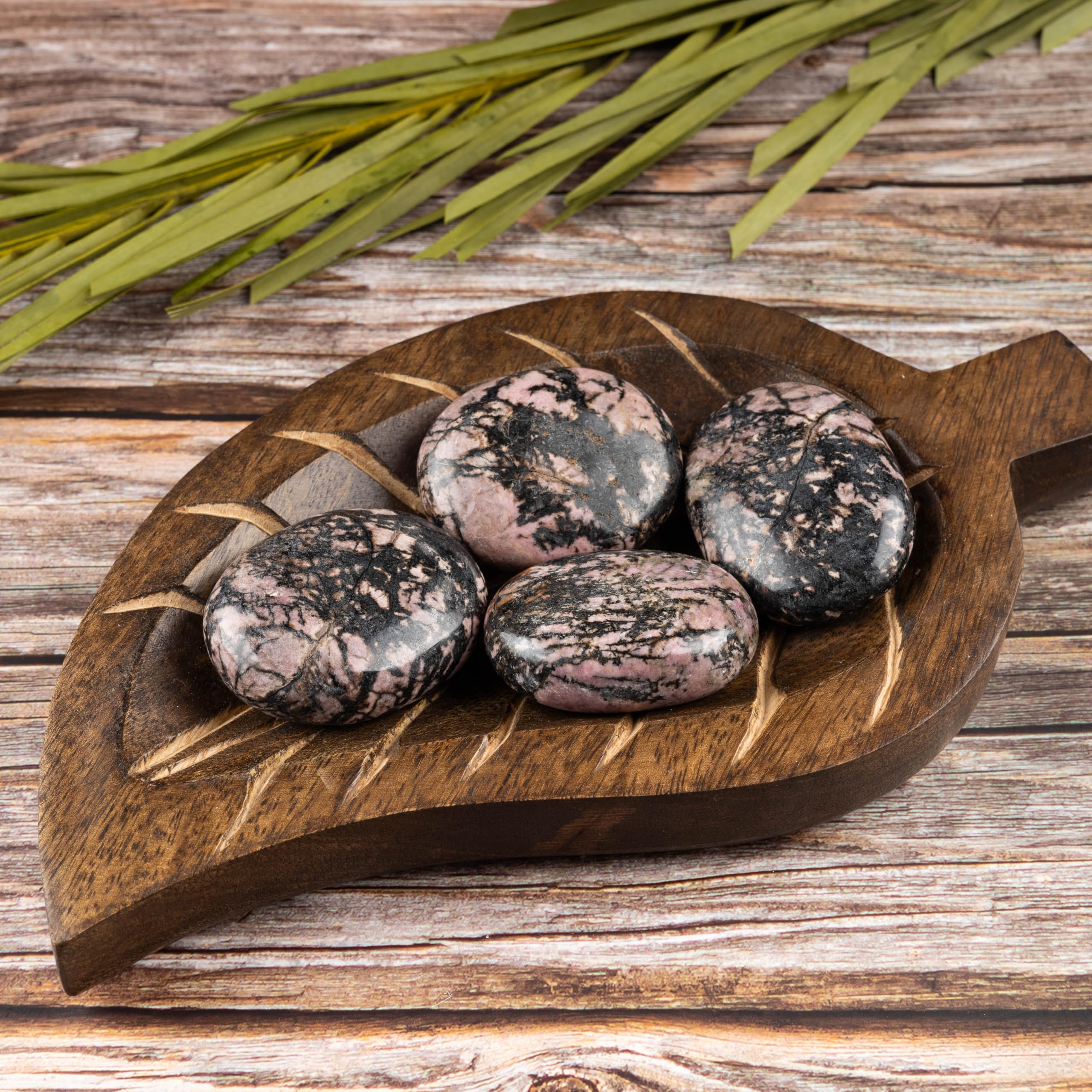Wish Well Rhodonite palm stone surface supports tactile calm practice