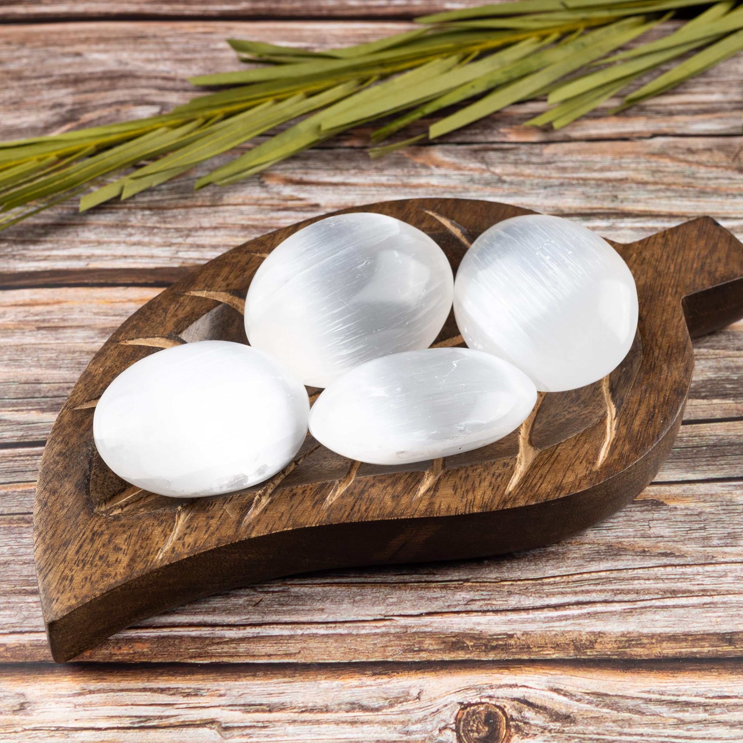 Wish Well selenite palm stone presented with velvet pouch for gifting.