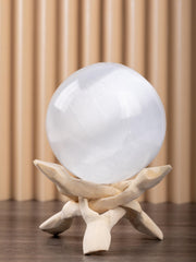 Wish Well selenite sphere on an altar for tranquil meditation focus.