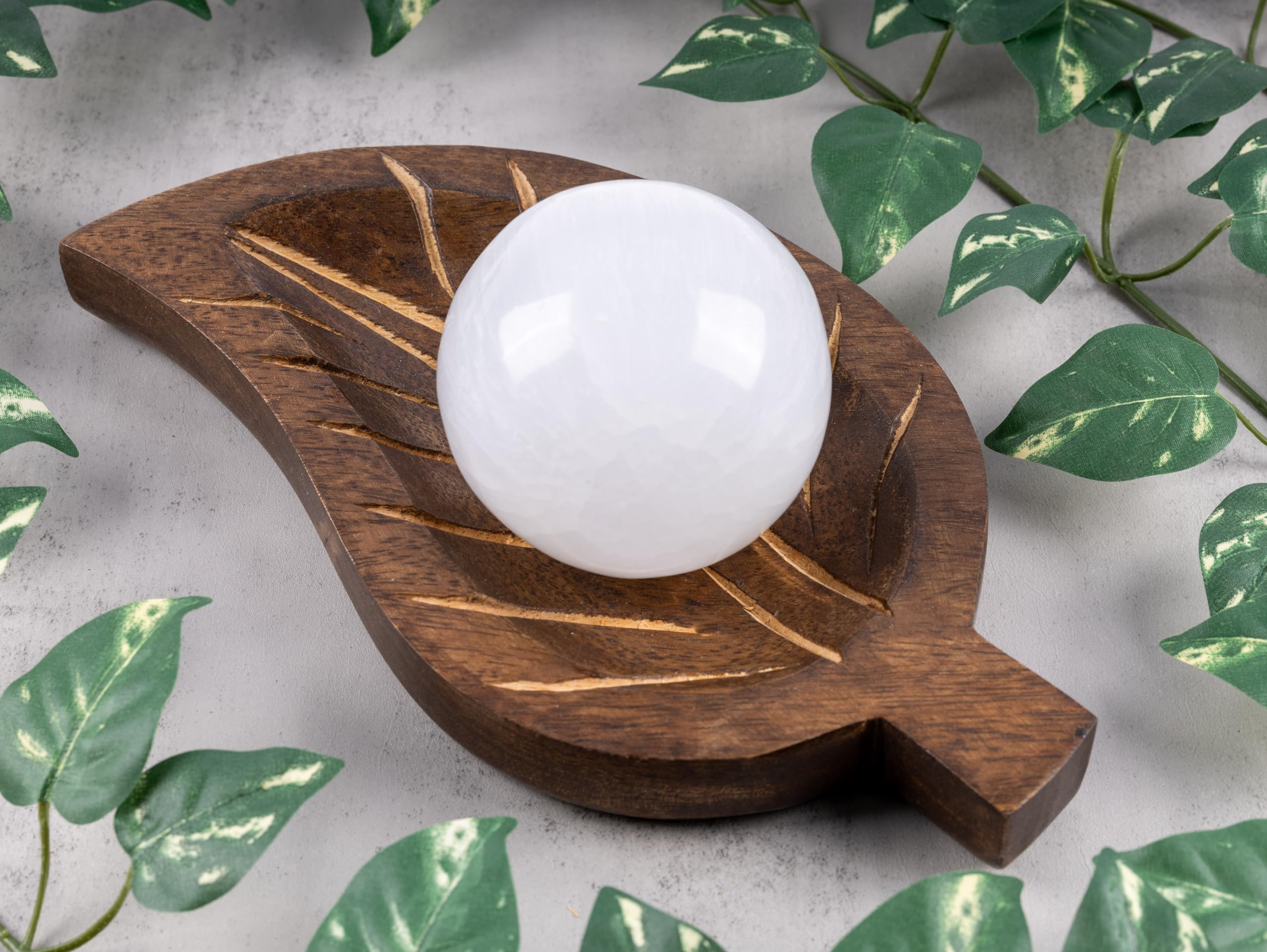 Wish Well selenite sphere with a 4-inch wooden stand displayed elegantly.