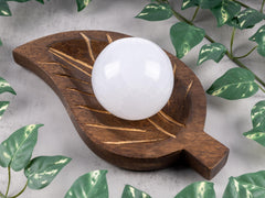 Wish Well selenite sphere with a 4-inch wooden stand displayed elegantly.
