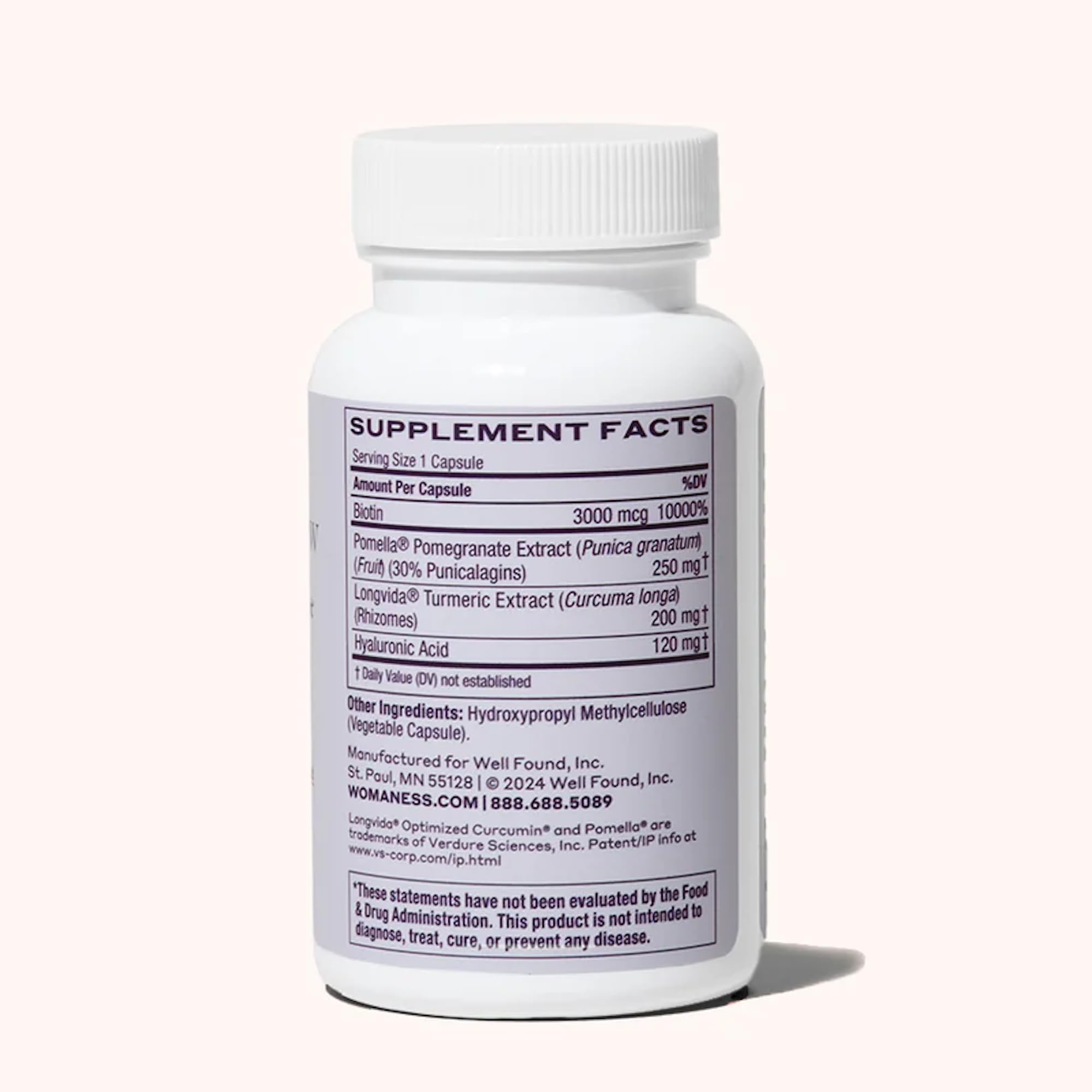 Womaness Active Glow capsules closeup featuring biotin and hyaluronic acid for hair and skin support