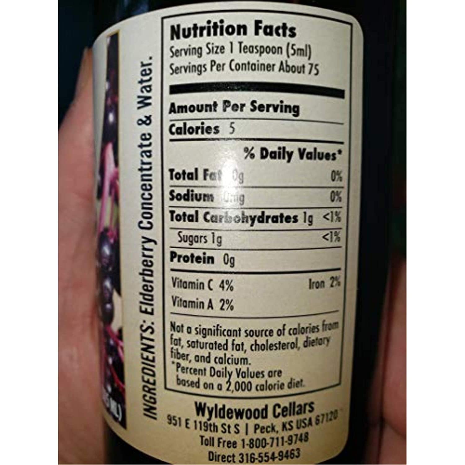 Wyldewood Elderberry concentrate poured into a glass for a natural, flavorful beverage option.