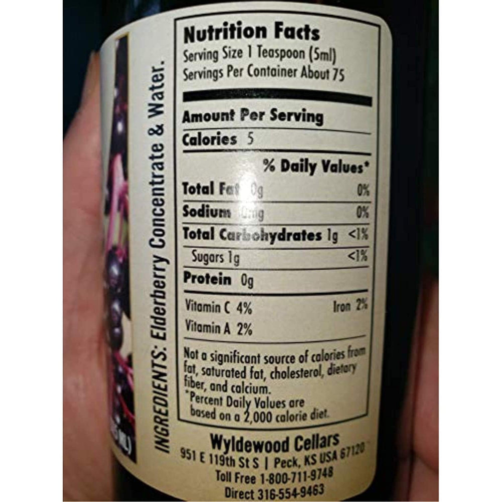 Wyldewood Elderberry concentrate poured into a glass for a natural, flavorful beverage option.