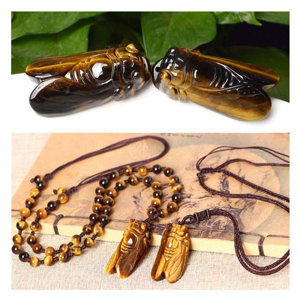 Ximimark tiger's-eye cicada pendant held in hand, easy to style on the go.