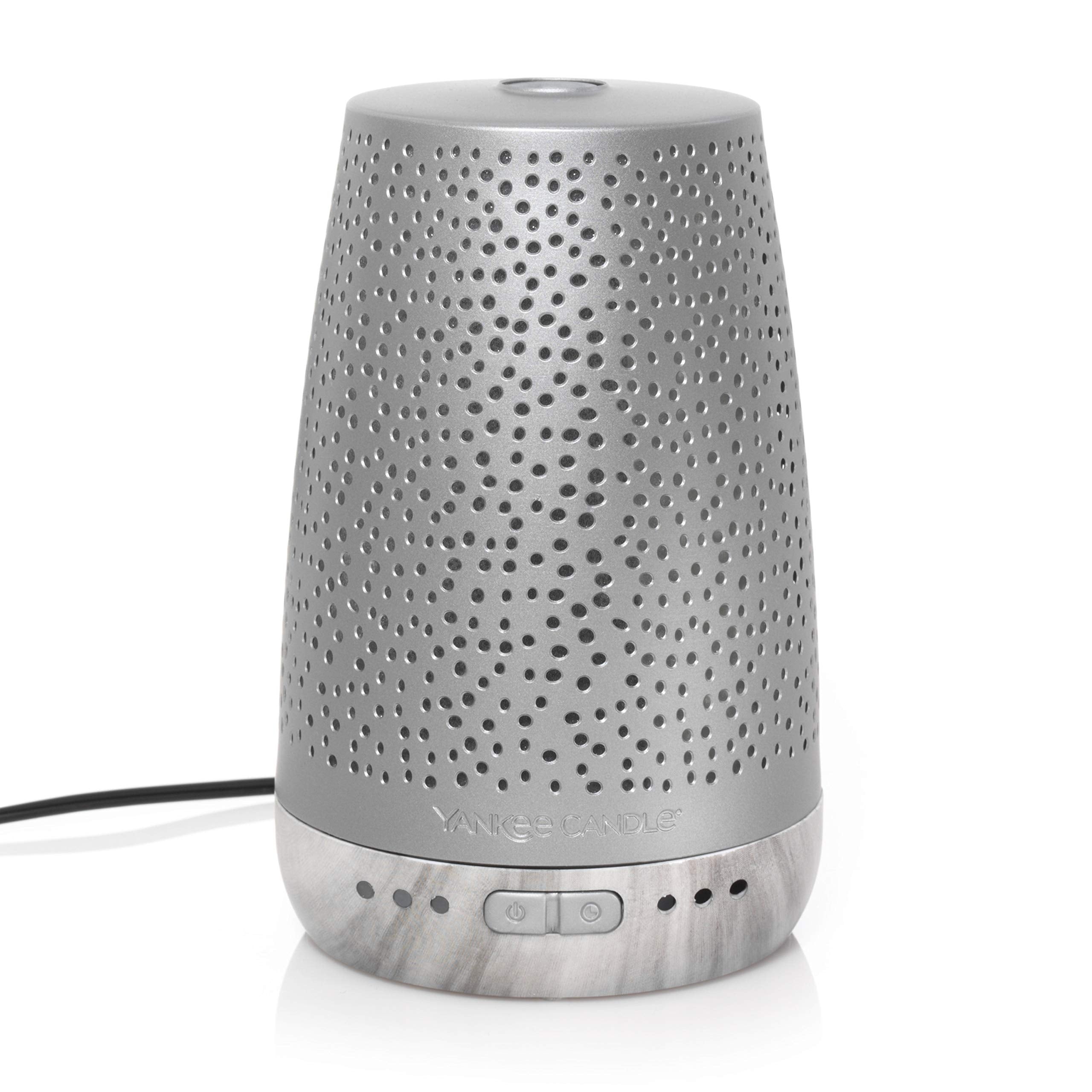Yankee Candle Sleep Diffuser in-bedroom scene suggests timer-based relaxation.