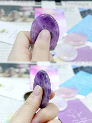 YATOJUZI worry stones in hand showing smooth surface for sensory relief.