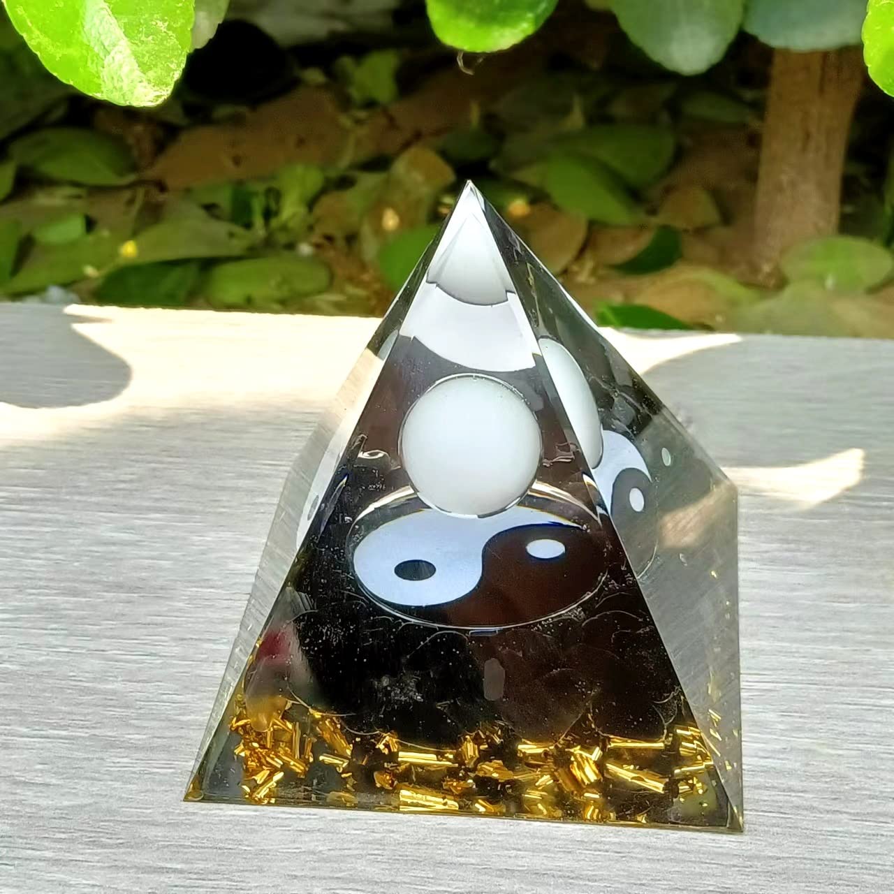 Ycyingcheng Moonstone Orgone Pyramid on shelf elevates room atmosphere and mindfulness.