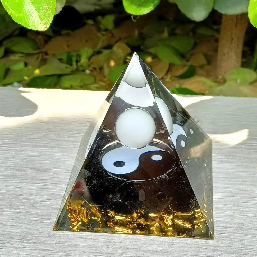 Ycyingcheng Moonstone Orgone Pyramid on shelf elevates room atmosphere and mindfulness.