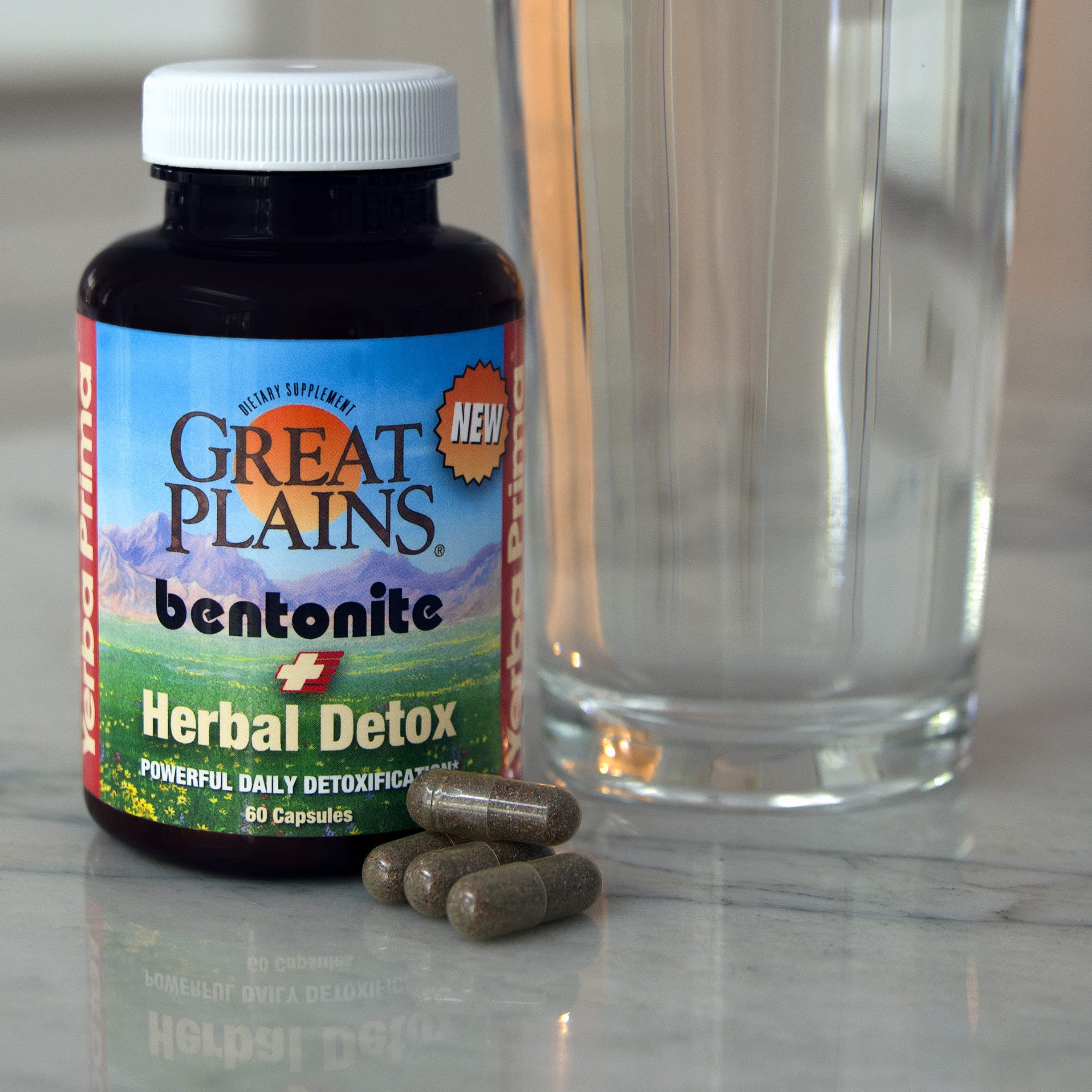 Yerba Prima Bentonite Clay Plus Herbal Detox capsules on surface with water