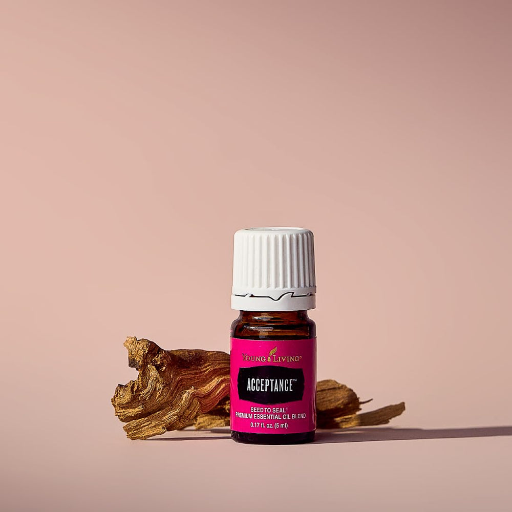 Young Living Acceptance bottle beside diffuser, supporting focused meditation sessions.