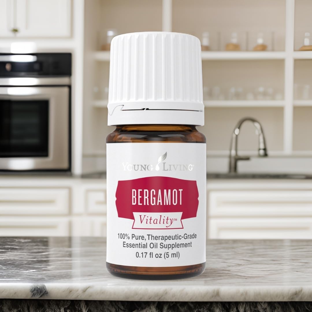 Young Living Bergamot Vitality with fresh bergamot fruit in the background.