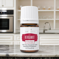 Young Living Bergamot Vitality with fresh bergamot fruit in the background.