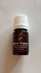 Young Living Black Pepper oil bottle pour for an energizing aroma.