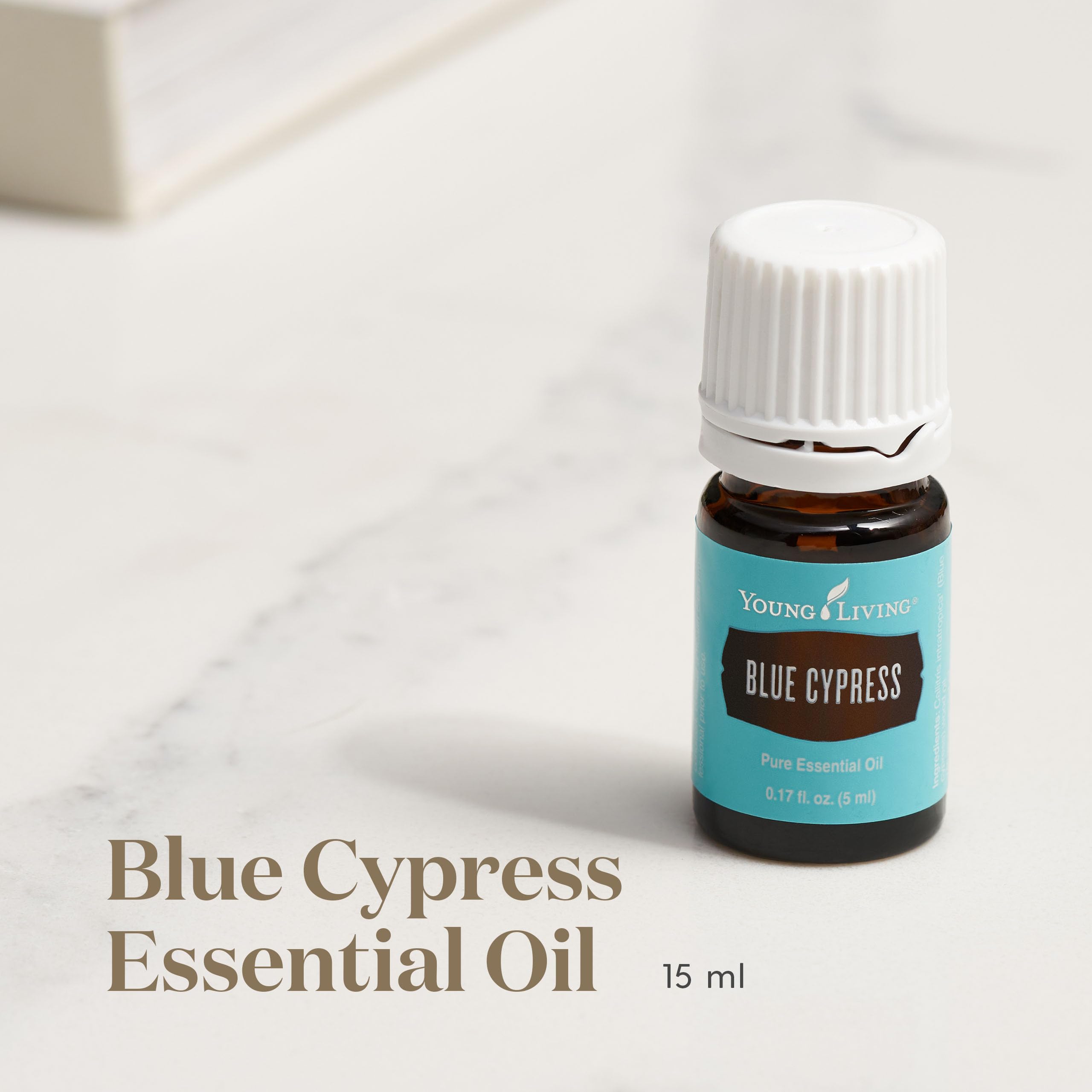 Young Living Blue Cypress amber bottle captures outdoor aroma for uplifting moments