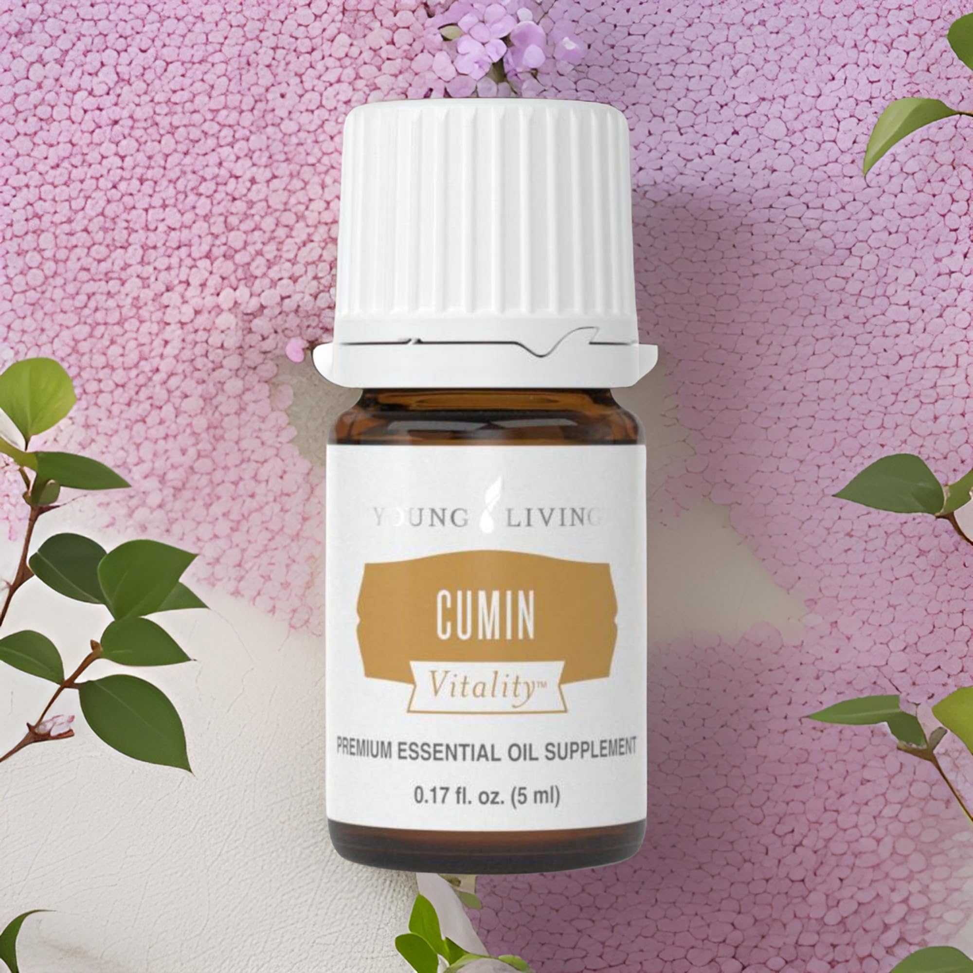 Young Living Cumin Vitality bottle on a clean kitchen counter ready for cooking.