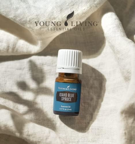 Young Living Idaho Blue Spruce bottle in a spa setting for emotional balance.
