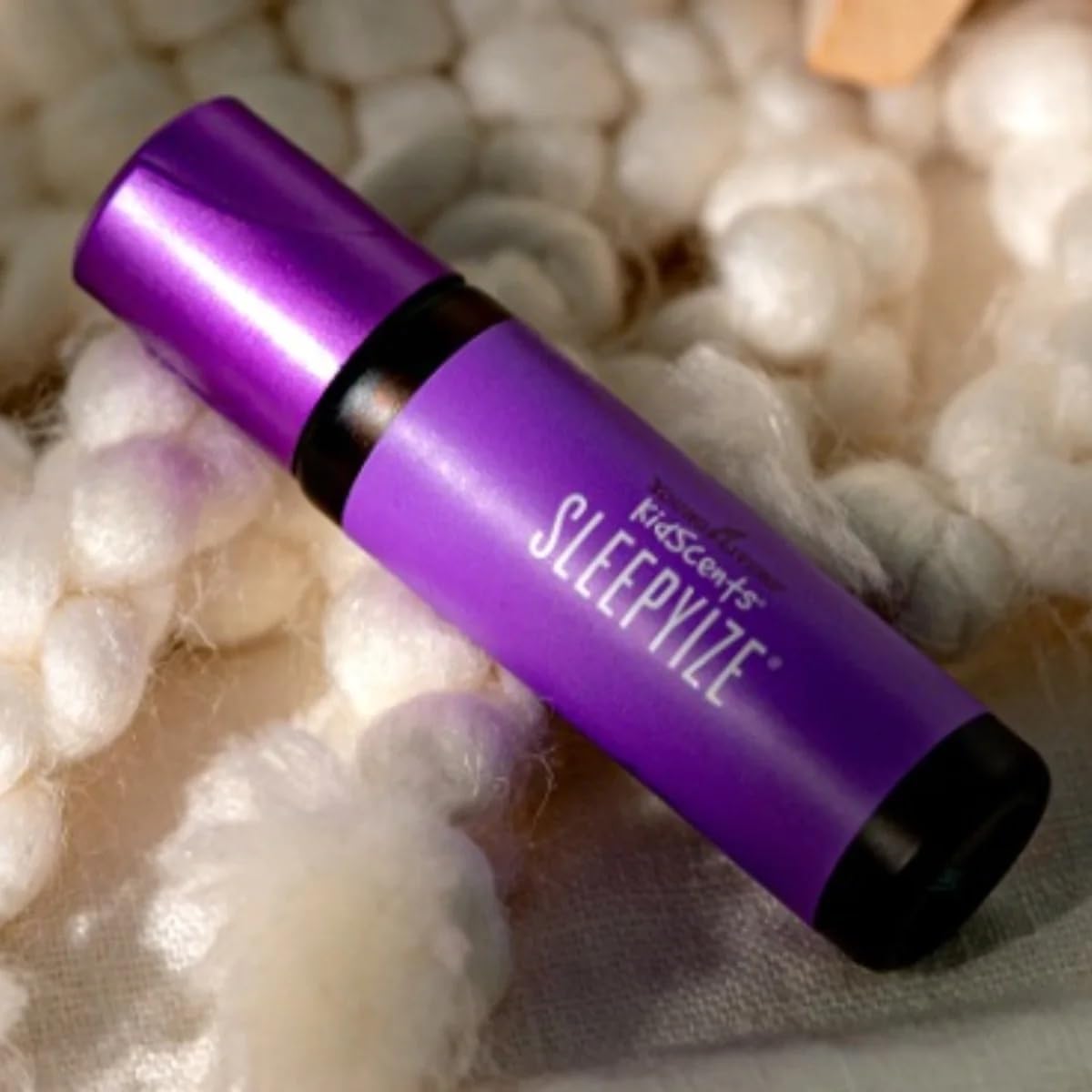 Compact 10 ml SleepyIze roll-on beside a storybook on a nightstand