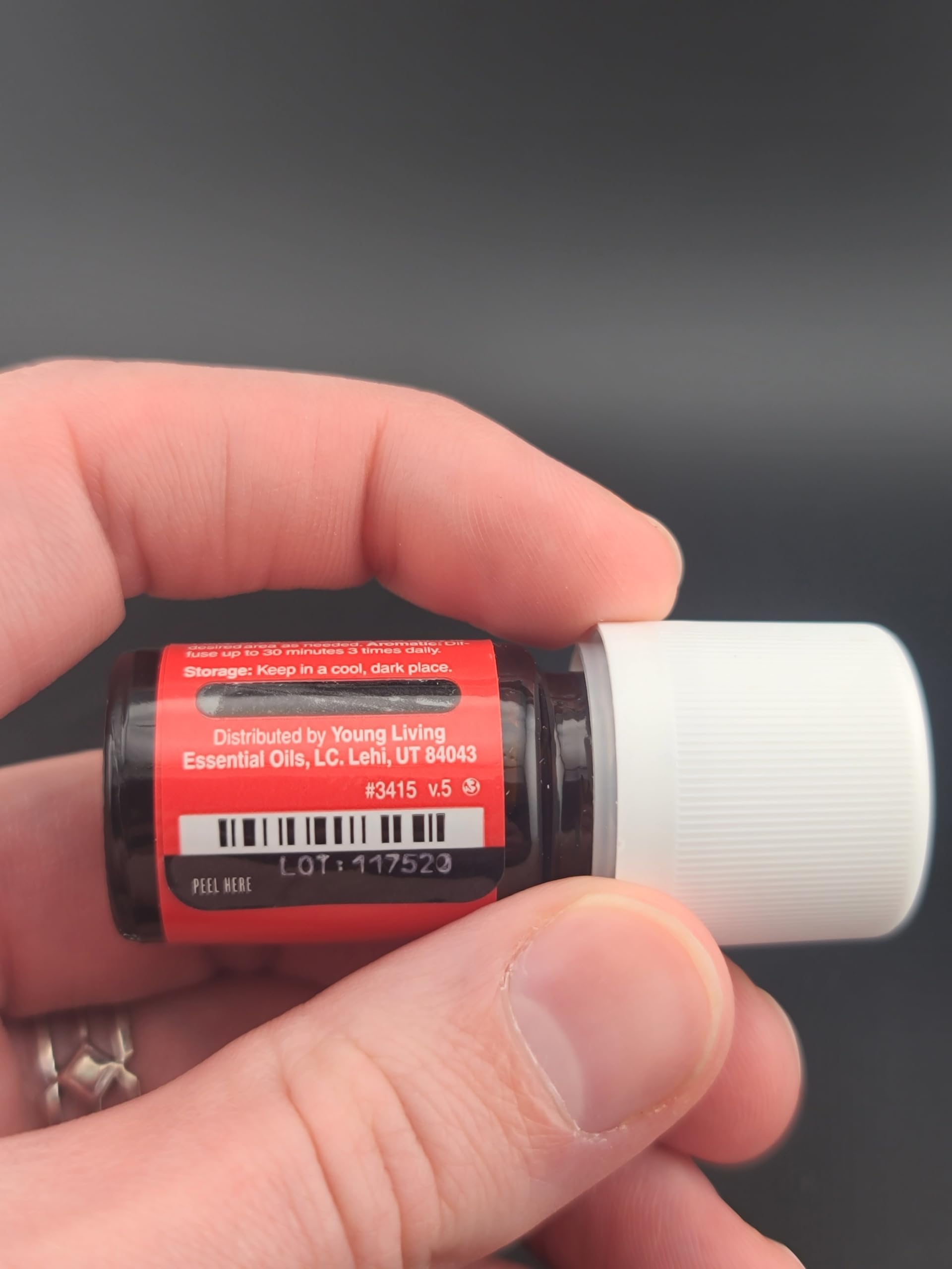 Raven essential oil bottle label showing vegan and kosher-certified attributes.
