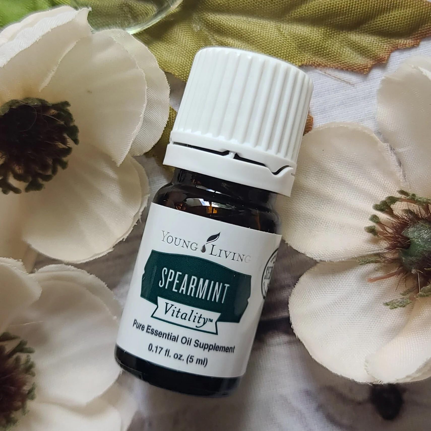 Young Living Spearmint Vitality bottle pour highlighting minty drizzle potential.