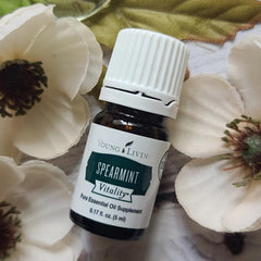 Young Living Spearmint Vitality bottle pour highlighting minty drizzle potential.