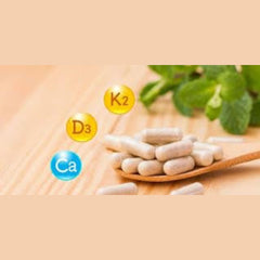 Young Living Super Cal Plus capsules on a bright surface for convenient daily supplementation.