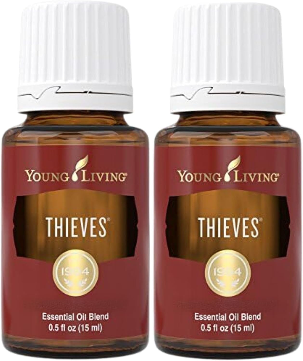 Young Living Thieves bottle beside a diffuser for a warm, inviting aroma.