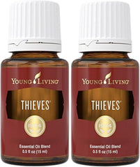 Young Living Thieves bottle beside a diffuser for a warm, inviting aroma.