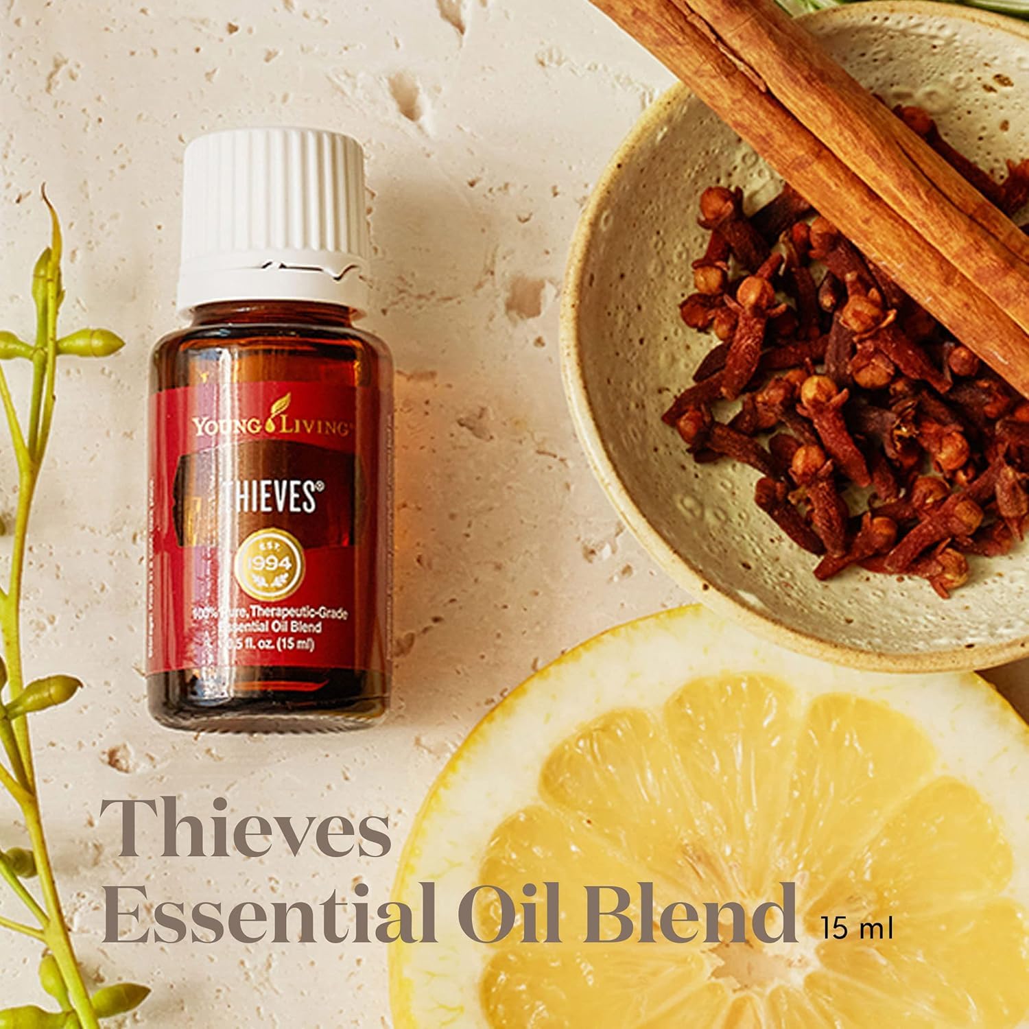 Young Living Thieves bottle being poured for a DIY cleaning spray.