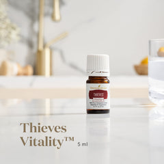 Young Living Thieves Vitality bottle closeup, highlighting premium botanicals and authenticity in every drop.