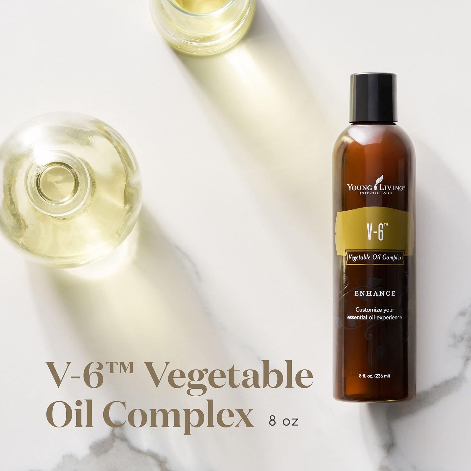 Pouring Young Living V-6 Enhanced oil for massage and blends.