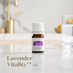Pouring Young Living Vitality Lavender Oil for flavoring drinks