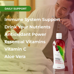 Aloe vera leaves and fresh cherries beside the bottle
