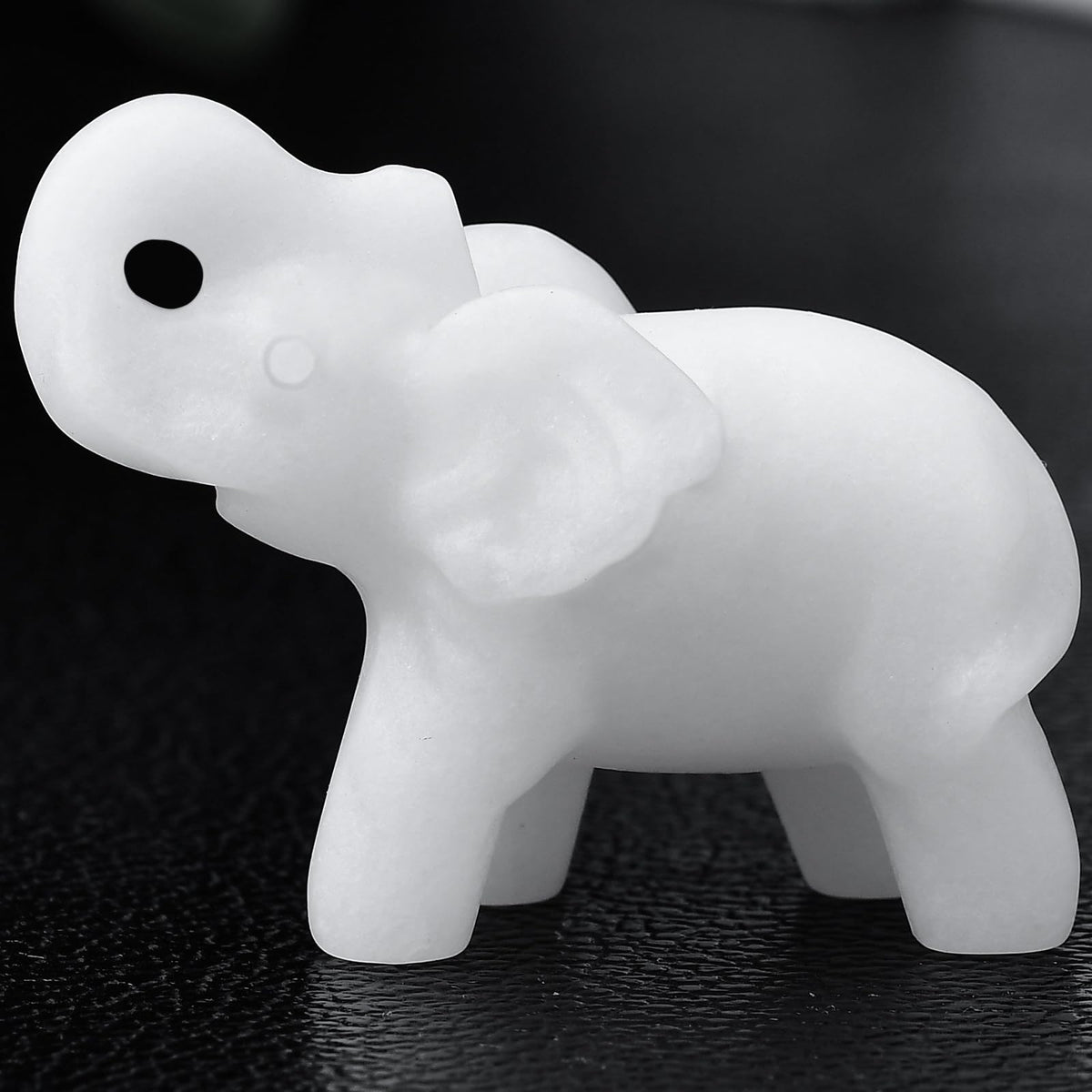 Ytbeoxk white jade elephant figurine close-up showing smooth finish and calming desk presence.