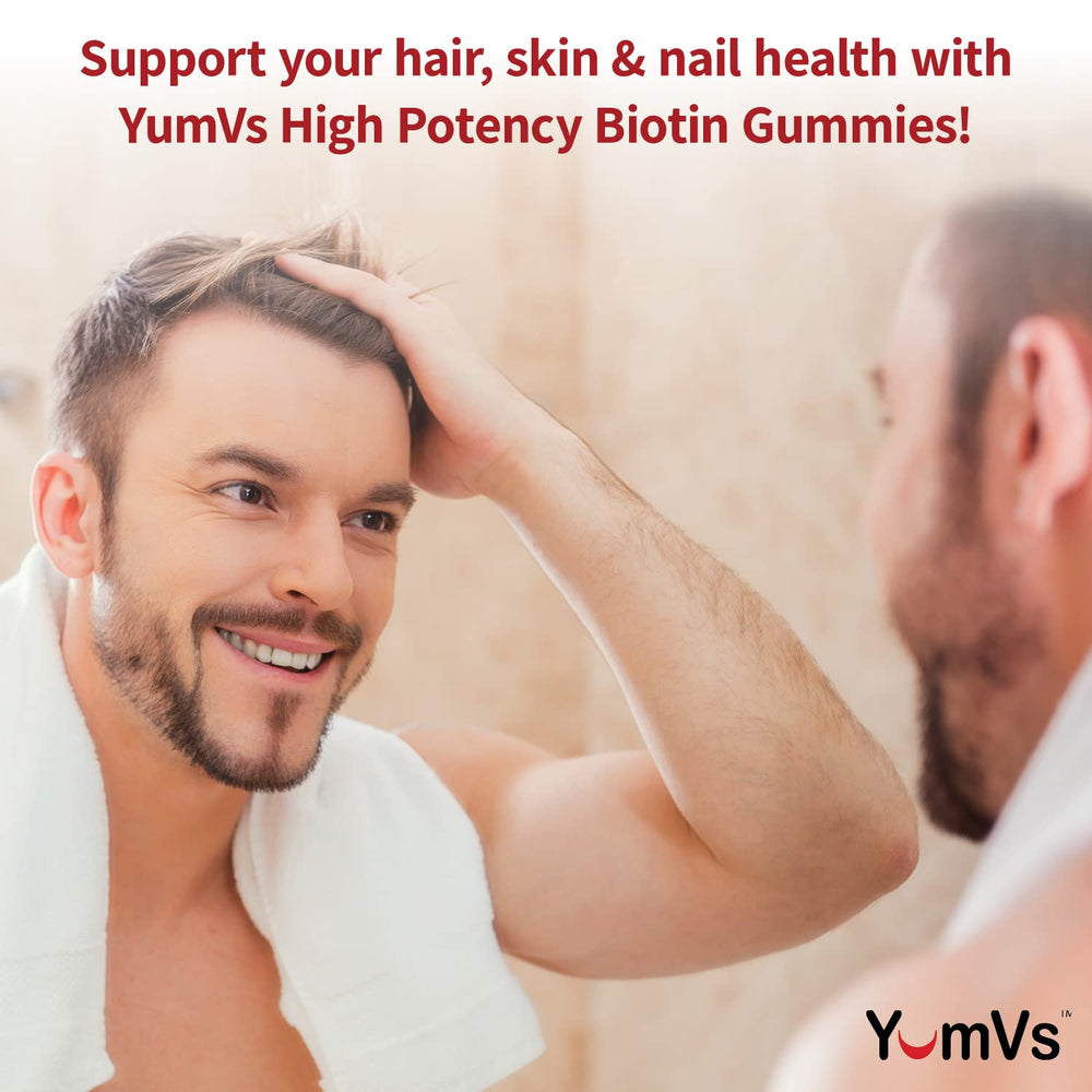YUM-V'S Biotin Gummies on hand show a chewy texture for an easy daily routine.